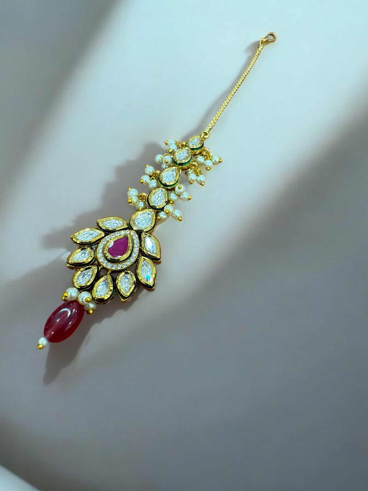 Exquisite Kundan Maang Tikka with Pearl & Red Stone Accents